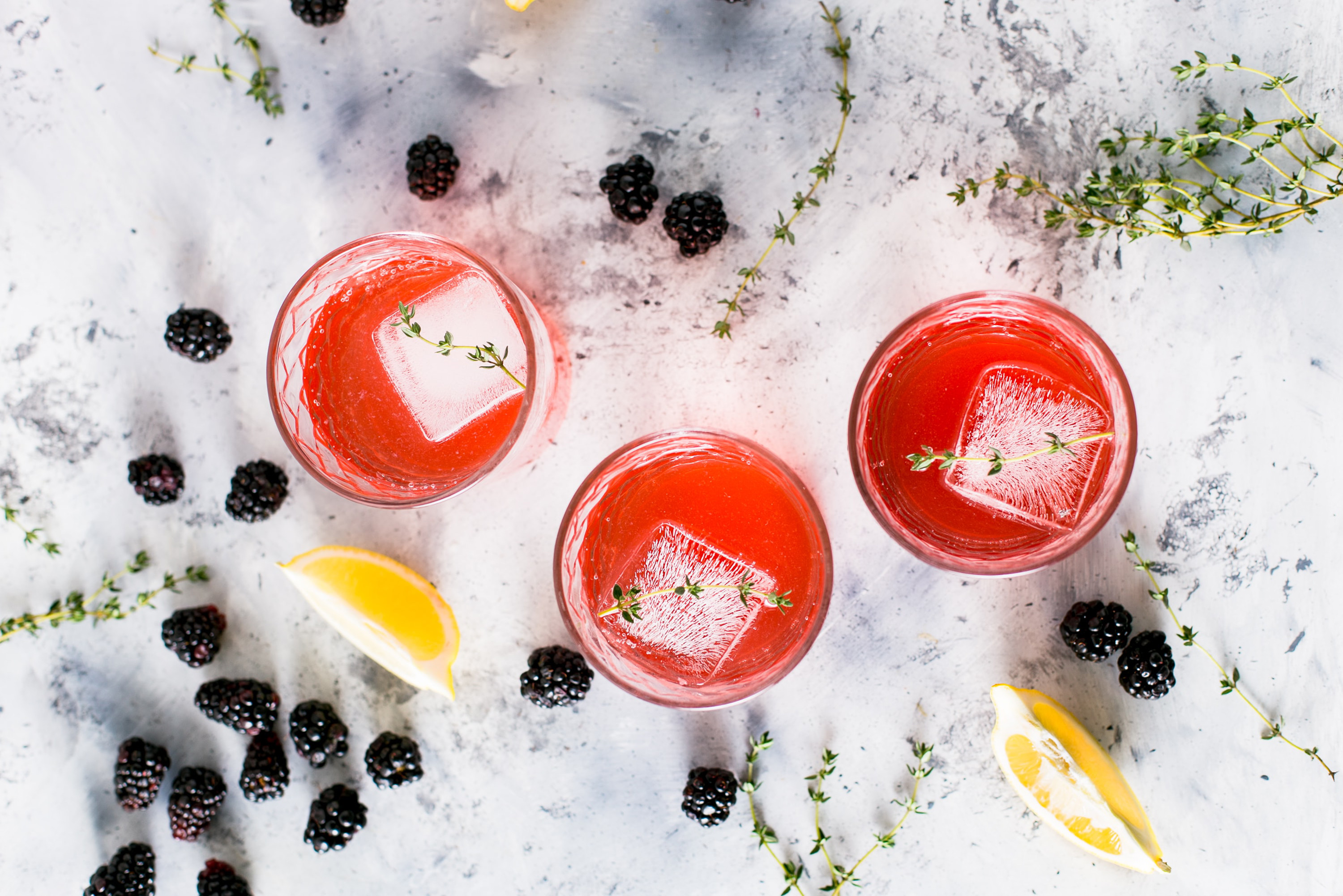 Shot from above, three blackberry cocktails.