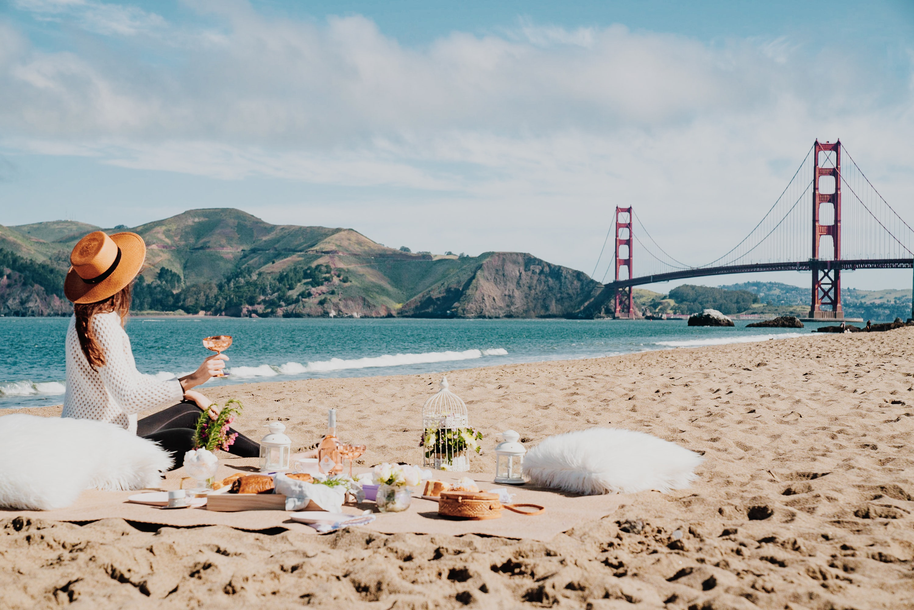 Woman having a picnic with view of the Golden Gate Bridge.