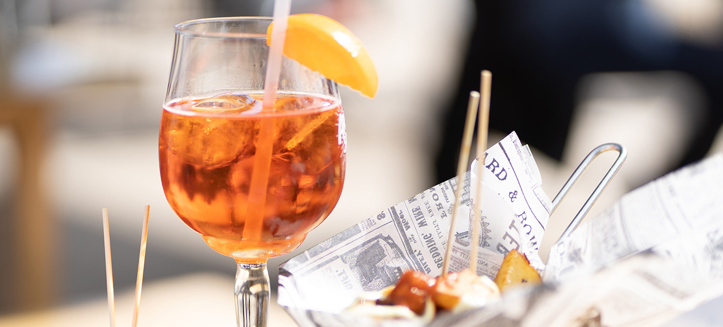 Aperol Spritz, olives, and appetizers.